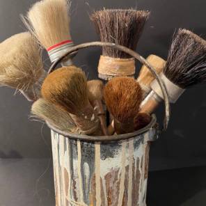20th century French brushes in metal bucket
